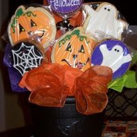 Halloween Bouquet NINE flippin cookies in a 50 cent plastic cauldron. Had to hot glue the tallest middle one in the hole. Used lollipop sticks intead of...