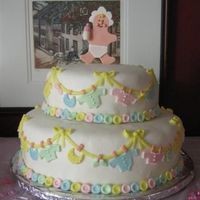 Clothesline Baby Shower Cake from the wilton yearbook (2006 I think). The baby on top is made of gumpaste. Covered in marshmallow fondant with marshmallow fondant...