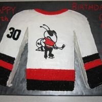 Hockey Jersey Cake Cake for a 6 year old based on his hockey jersey. Covered in buttercream. Cut from a 16" square cake.