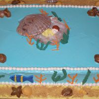 Fish Themed Baby Shower Cake butter cake with strawberry filling and Whimsical Bakehouse buttercream. Chocolate shells, fondant fish, royal icing sea weed.