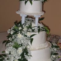 First Wedding Cake Buttercream. Had trouble cutting bottom layer straight. Very nervewracking assembling cake.