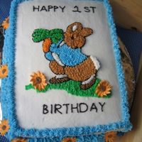Peter Rabbit Buttercream with royal icing flowers. Printed picture off internet and cut out image and laid on cake. Traced with toothpick.
