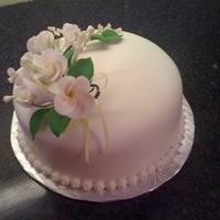 Birthday Cake 8" round; MMF covered; chocolate cake with caramel filling; gumpaste floral spray.