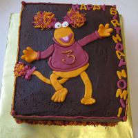 Fraggle Rock Cake Red Fraggle for my niece.To get her pigtails multi-colored like that I piped the orange and red icing into one bag and then used my '...
