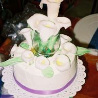 Close Up Of Calla Lily Bouquet This is a cake for a 10th anniversary celebration. The calla lillies and leaves were made from fondant and the stems were made from a...