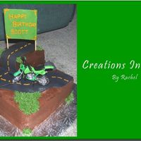 Motorcycle Cake This is a chocolate cake with raspberry filling and chocolate buttercream. The road, rocks, and sign are fondant and I cheated and got the...