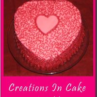 Pink & Red Heart White cake with Raspberry filling. Pink butter cream and red buttercream detail.