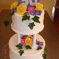 50Th Anniversary Wanted to replicate an older cake w/the pillars. Buttercream iced, gumpaste flowers, ivy and plaque.