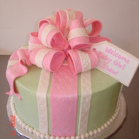 Pink And Green Buttercream iced w/fondant stripes, bow and pearls.