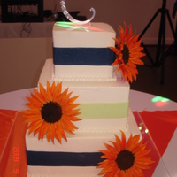 Burnt Orange Sunflowers Buttercream iced w/fondant ribbons and gumpaste sunflowers.
