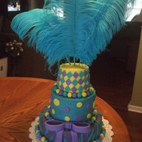 Purple, Yellow,turqouise Buttercream w/fondant zebra, dots, & diamonds w/feathers on top & fondant bow
