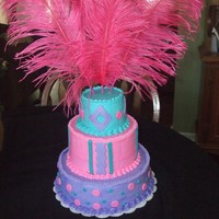 Purple, Turquoise & Pink Buttercream w/fondant dots, stripes, & diamonds w/feathers on top