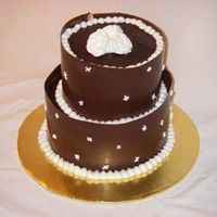 Chocolate Wrap Wedding This is a choclate cake filled and frosted with Toba Garrett's Chocolate frosting and then wrapped with a chocolate wrap. RI roses on...