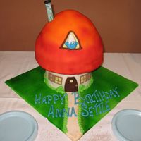 Smurf Cake 3-d cake of a mushroom house of a Smur. It's covered in fondant and colored with an airbrush.