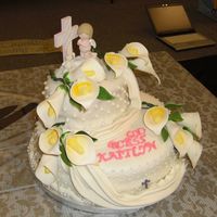 Baptism Cake 12" round with a 7. 3/4 oval. Vanilla sponge with vanilla custard. I first covered each tier with marzipan and then fondant. Gum paste...