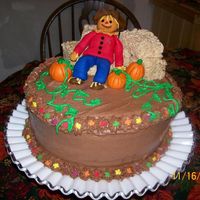 Fall Chocolate cake with chocolate bc. Rice krispies hay bales and first time fondant figure and pumpkins. Idea from this site, of course....