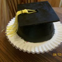 Graduation Chocolate cake with chocolate bc tinted black. Mortarboard is fondant covered cardboard with black jellybean button. Fondant tassel. Thanks...