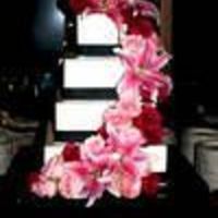 Crystal This was a New Year's Wedding Cake with IMBC. Each square tier was wrapped with a black satin ribbon and rhinestone trim at the bases...