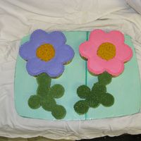 Flower Cupcake Cake The flowers are made out of regular size cupcakes and the stems are mini cupcakes! Fun to do :-)