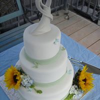 Sunflower Wedding Cake Vanilla rum cake covered in fondant. Gumpaste butterflies and real flowers. Thanks for looking.