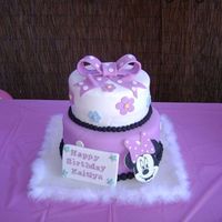 Minnie Mouse Cake Color on the picture came out a little purple, the actual color was more pink. Vanilla rum cake covered in fondant. Gumpaste and fondant...