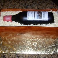 Wine Bottle Cake WASC chocolate cake with chocolate mocha icing. Gumpaste bottle with fondant woodgrain crate. Many thnaks to everyone on CC"s help!
