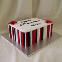Black, Red And White 7 x 9 inch white chocolate mud cake covered in white fondx and then covered in fondnt stripes. Gumpast lettering. Made at customer rqst.All...