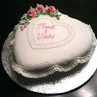 Heart Cake White cake with buttercream filling and covered in rolled fondant. The roses don't look quite the same pink as on the cake, and my...