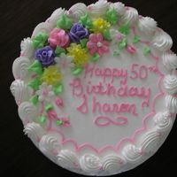 Simple Birthday Cake White cake with whipped icing and filling; decorated with buttercream flowers.