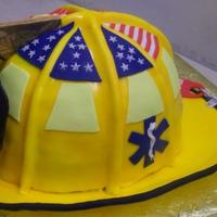 Friestatt Firefighter Helmet Replica of a Friestatt Missouri Firefighters helmet. 8 inch cakes cut to ressemble a carines 1010 helmet, complete with gumpaste ribs...