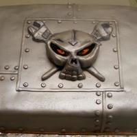 Skull Cake Sheet cake covered with fondant, sprayed with Nu-Silver. Skull with glarring eyes is fondant.