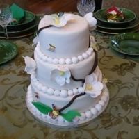 Butterflies And Flowers This was a lot of fun to make. Ivory Fondant, German Chocolate with SemiSweet Chocolate Grenace filling. 10"8"6" tiered....