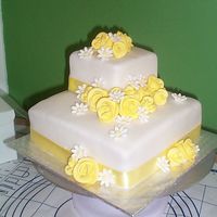 My First Wedding Cake! fondant over buttercream, lemon b/c between layers, 4" and 8" squares, client bought the roses and daisies cuz I chickened out on...