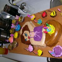 Bratz Girl I used my Wonder woman cake pan to do this one. We put hair over the tiara, widened her face with frosting and made the rope into a table....