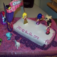 Fashion Model Runway Cake The characters are from the chixos fashion model toy set and the pet shops are the audience.