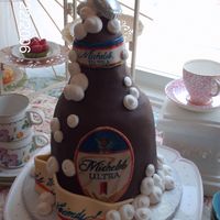 Grooms Cake Its way to fat for a beer bottle.........hand carved # cake covered in chocolate wrap and hand painted label,RI bubbles.
