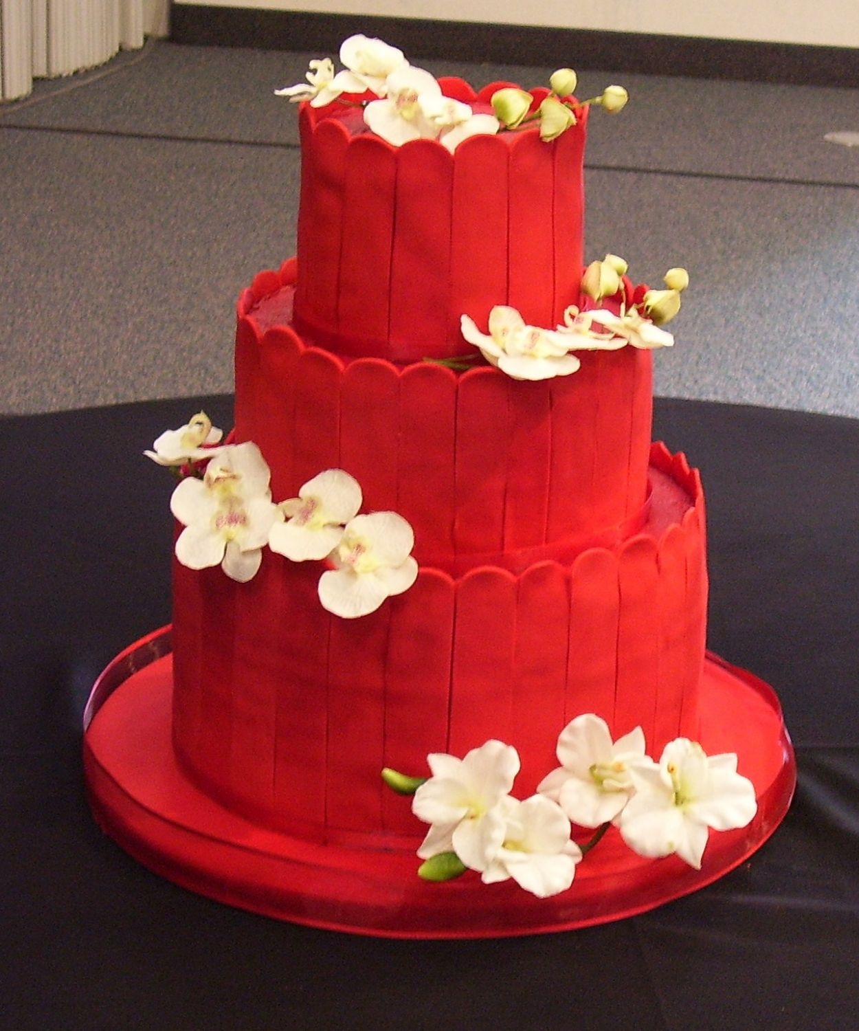 Red Asian Themed Wedding This is a very red cake! Lots and lots of food color! Frosted red with red satin ice slats around the layers. This is my first real wedding...