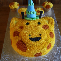 Giraffe Character bear face cake decorated as a giraffe, sugar waffle cone used for the hat covered with MFF. Made cupcakes with buttercream icing...