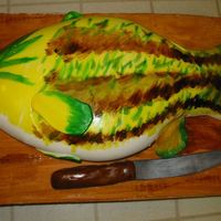 Fish Cake This is covered with marshmallow fondant. The cake board is also covered in fondant to look like a cutting board. I also made the knife...