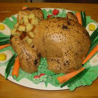 Turkey Cake All of the vegtables are made with marshmallow fondant. The cake is iced with crusting buttercream and sprayed with liquid brown sugar.