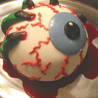 A Witch Holding An Eyeball this is made with the sports ball pan and marshmallow fondant