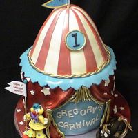 Carnival Tent THIS CAKE WAS MADE TO MATCH THE PARTY INVIATIONS. IT WAS A CARNIVAL THEMED PARTY. THE CLOWN AND THE HORSE ARE MADE FROM GUMPASTE/FONDANT....
