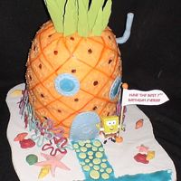 Spongebob's Pineapple Under The Sea SPONGEBOB CAKE FOR MY DAUGTHER'S BIRTHDAY. THE SPONGEBOB HIMSELF IS PLASTIC. THE FLOWERS AROUND THE BASE OF THE HOUSE ARE MADE CANDY...