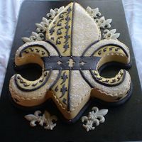Black And Gold Fleur De Lis This was a groom cake for a couple who are big Saints fans. Hand carved - very hard to cover in fondant!!!!!