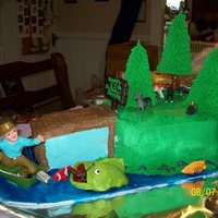 Fisherman This was a vanilla and chocolate cake for my sons 11th bday. Everything is edible except the fisherman and little plastic animals. The big...