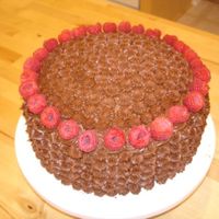 My Mother-In-Law's Birthday Cake It is chocolate cake, torted and filled with raspberry cream filling. It is iced with chocolate buttercream icing. Just simple star...
