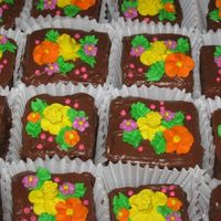 Chocolate Mini Cakes milk chocolate cake with chocolate buttercream filling and iced with chocolate. royal icing flowers