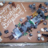 Lego Indiana Jones I made this cake for my great-nephew. It is yellow cake with choc. BC icing. Rocks, snakes, skulls and bones are fondant. The lego kit I...