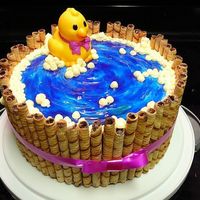 Rubber Duck In A Tub Baby shower cake for a friend. I love how this turned out. the watter was made by frosting white buttercream in a spiral then covering it...