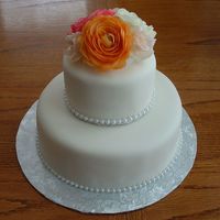 Simple & Elegant This wedding cake was done for my father in law. The cakes were lemon with vanilla BC, covered in MMF topped with silk flowers.